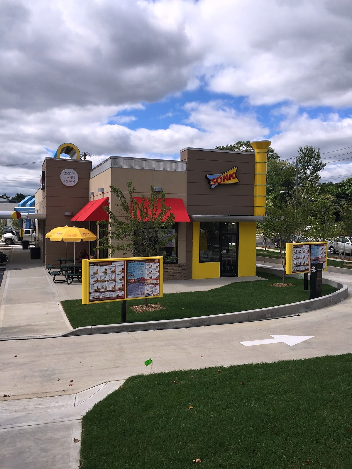Sonic Drive-In building with menu boards, lawn and drive lane